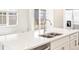 Kitchen island with stainless steel faucet, double sink, and view of the window at 781 N Tempe St, Aurora, CO 80018