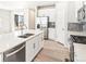 Kitchen island with stainless steel appliances, double sink, and white cabinets at 781 N Tempe St, Aurora, CO 80018