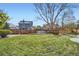 Expansive backyard with lush green grass and a well-maintained wooden fence surrounding the property at 9523 Sherrelwood Ln, Highlands Ranch, CO 80126