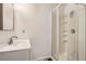 Small, basic bathroom featuring a shower stall, a sink, medicine cabinet, and simple design at 9523 Sherrelwood Ln, Highlands Ranch, CO 80126