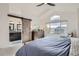 Well-lit bedroom with en suite featuring a sliding barn door, and a view at 9523 Sherrelwood Ln, Highlands Ranch, CO 80126