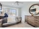 Comfortable bedroom boasts bright natural light and a ceiling fan at 9523 Sherrelwood Ln, Highlands Ranch, CO 80126
