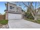 Well maintained home with large windows above the garage and a concrete driveway leading to the street at 9523 Sherrelwood Ln, Highlands Ranch, CO 80126