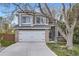 Charming home featuring a two-car garage, gray siding, brick accents and a well-maintained lawn at 9523 Sherrelwood Ln, Highlands Ranch, CO 80126