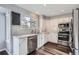 Well-lit kitchen featuring white cabinets, stainless steel appliances, and hardwood flooring at 9523 Sherrelwood Ln, Highlands Ranch, CO 80126