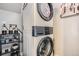 Modern stacked washer and dryer with detergents next to it, great for efficiently managing laundry tasks at 9523 Sherrelwood Ln, Highlands Ranch, CO 80126