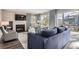 Bright living room boasts modern fireplace, dark wood floors, and access to the backyard at 9523 Sherrelwood Ln, Highlands Ranch, CO 80126