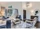 Inviting living room featuring a large window, stylish decor, and elegant hardwood floors at 9523 Sherrelwood Ln, Highlands Ranch, CO 80126