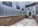 Back porch features a corrugated steel exterior with a brick base and tiled floors at 4144 Tennyson St # 212, Denver, CO 80212