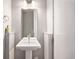 Clean half-bathroom with a white pedestal sink, modern fixtures, and a minimalistic design at 4144 Tennyson St # 212, Denver, CO 80212