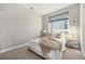 Well-lit bedroom with carpet, queen-sized bed, window, and matching nightstands and lamps at 4144 Tennyson St # 212, Denver, CO 80212