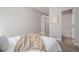 Cozy bedroom featuring carpet, queen-sized bed, view into bathroom and closet at 4144 Tennyson St # 212, Denver, CO 80212