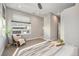 Bright bedroom featuring neutral tones, tray with book and plant on the bed, and decorative art at 4144 Tennyson St # 212, Denver, CO 80212