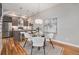 Stylish dining area with modern lighting, seating, and a view into the adjacent kitchen at 4144 Tennyson St # 212, Denver, CO 80212