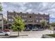 Modern brick building with visible rooftop access, street parking, and landscaping at 4144 Tennyson St # 212, Denver, CO 80212