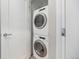 Compact laundry closet with stacked washer and dryer for efficient space-saving at 4144 Tennyson St # 212, Denver, CO 80212