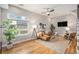 Bright living room with a large window, ceiling fan, hardwood floors, and comfortable furniture at 4144 Tennyson St # 212, Denver, CO 80212