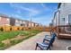 Backyard featuring a wood fence, grass area, patio area, and two chairs for outdoor relaxation at 19121 E 65Th Ave, Denver, CO 80249