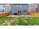 Backyard with a wood fence, grass area, patio area, and outdoor grill for entertainment at 19121 E 65Th Ave, Denver, CO 80249
