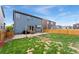 Backyard with a wood fence, grass area, patio area, and outdoor grill for entertaining at 19121 E 65Th Ave, Denver, CO 80249