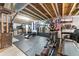 Home gym featuring equipment, storage and US flag at 19121 E 65Th Ave, Denver, CO 80249