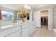 Modern bathroom featuring double sinks, quartz countertops, and ample storage space at 19121 E 65Th Ave, Denver, CO 80249