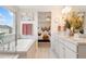 Bathroom featuring double vanity, tub with a shower and a neutral color palette at 19121 E 65Th Ave, Denver, CO 80249
