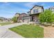 Inviting two-story home showcasing a manicured front yard and stone-accented porch at 19121 E 65Th Ave, Denver, CO 80249