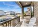 Cozy front porch with stone columns, seating, and a view of the neighborhood at 19121 E 65Th Ave, Denver, CO 80249