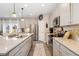 Modern kitchen featuring stainless steel appliances, quartz countertops, and a spacious center island at 19121 E 65Th Ave, Denver, CO 80249
