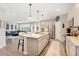 Open-concept kitchen with a large island, stainless steel appliances, and sleek cabinetry at 19121 E 65Th Ave, Denver, CO 80249
