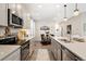 Modern kitchen featuring quartz countertops, stainless steel appliances, and an adjacent dining area at 19121 E 65Th Ave, Denver, CO 80249