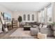 Comfortable living room with a gray sectional, large windows, and stylish decor at 19121 E 65Th Ave, Denver, CO 80249