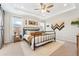 Bright main bedroom with tray ceiling, comfortable bed, and stylish decor at 19121 E 65Th Ave, Denver, CO 80249