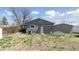View of the home's backyard with a shed and partial view of the gray vinyl siding at 575 2Nd St, Bennett, CO 80102