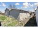 View of the home's backyard with a partial view of the gray vinyl siding at 575 2Nd St, Bennett, CO 80102
