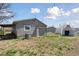 View of the home's backyard with a shed and partial view of the gray vinyl siding at 575 2Nd St, Bennett, CO 80102