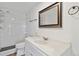 Clean bathroom featuring subway tiles in the shower, a large mirror, and a modern white sink at 575 2Nd St, Bennett, CO 80102