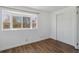 Bright bedroom with natural light from the bay window, featuring laminate flooring and a spacious closet at 575 2Nd St, Bennett, CO 80102