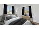 Cozy bedroom featuring neutral decor, comfortable bed, and dresser with a decorative display at 575 2Nd St, Bennett, CO 80102