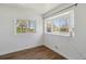 Bright bedroom with hardwood floors and large windows allowing ample natural light and outdoor views at 575 2Nd St, Bennett, CO 80102