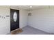 Covered front porch featuring a sleek black door with oval window and a welcoming doormat at 575 2Nd St, Bennett, CO 80102