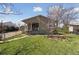 Charming single-story home with a well-maintained lawn and inviting front porch, perfect for enjoying the outdoors at 575 2Nd St, Bennett, CO 80102
