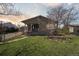 Inviting home featuring a well-maintained lawn and a cozy front porch at 575 2Nd St, Bennett, CO 80102