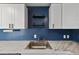Close-up of a kitchen sink with marble countertops and modern fixtures at 575 2Nd St, Bennett, CO 80102