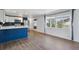 Open concept kitchen with white cabinets and stainless steel appliances with adjoining area at 575 2Nd St, Bennett, CO 80102