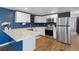 Bright kitchen with stainless steel appliances and an island with marble countertops at 575 2Nd St, Bennett, CO 80102