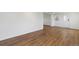 Open-concept living space featuring laminate flooring, freshly painted white walls, and an abundance of natural light at 575 2Nd St, Bennett, CO 80102