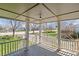 A covered front porch with white railings and plenty of room to relax at 575 2Nd St, Bennett, CO 80102