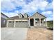 Inviting home showcasing a quaint covered porch, a two-car garage, and dormer windows for added charm at 3895 Buttongrass Trl, Castle Rock, CO 80108